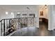 Hallway with decorative railing and trim, hardwood floors, a view to office area, and natural light at 10609 Chadsworth Ln, Highlands Ranch, CO 80126