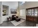 Cozy living room featuring high ceilings, dark wood floors, and a leather chair at 10609 Chadsworth Ln, Highlands Ranch, CO 80126