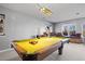 Finished basement featuring a billiard table and cushioned window seats at 4249 Oak Grove Way, Castle Rock, CO 80108