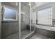 Elegant bathroom highlighting a frameless glass shower and a sleek, tiled tub at 4249 Oak Grove Way, Castle Rock, CO 80108