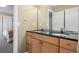 Bathroom featuring a double vanity with dark countertops and wood cabinetry, offering ample space and storage at 4249 Oak Grove Way, Castle Rock, CO 80108