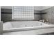 Luxurious bathroom featuring a jetted tub under a unique window providing ample natural light at 4249 Oak Grove Way, Castle Rock, CO 80108
