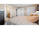 Cozy bedroom with a neutral color palette, featuring plush bedding and doorways to a closet and bathroom at 4249 Oak Grove Way, Castle Rock, CO 80108