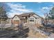 Charming exterior of a stone-clad home featuring a three-car garage and inviting walkway at 4249 Oak Grove Way, Castle Rock, CO 80108