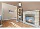 Cozy living room features a stone fireplace and wood floors at 4249 Oak Grove Way, Castle Rock, CO 80108