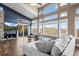 Bright living room with floor to ceiling windows, hardwood floors, and cozy seating area at 4249 Oak Grove Way, Castle Rock, CO 80108