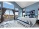 Bright main bedroom featuring vaulted ceiling, balcony access, and large windows offering scenic views at 4249 Oak Grove Way, Castle Rock, CO 80108