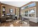 Bright home office featuring built-in desk, shelving and a large window showcasing picturesque views at 4249 Oak Grove Way, Castle Rock, CO 80108