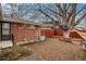 Brick paved patio in a backyard with mature trees at 6613 Independence St, Arvada, CO 80004