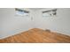 Bright bedroom features hardwood floors and natural light from the two windows at 6613 Independence St, Arvada, CO 80004
