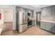 Modern kitchen featuring stainless steel appliances and gray cabinetry at 6613 Independence St, Arvada, CO 80004