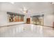 Bright living room with sliding glass doors and large windows overlooking the backyard at 6613 Independence St, Arvada, CO 80004