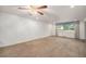 Large living room featuring plush carpeting and natural light from the window at 6613 Independence St, Arvada, CO 80004