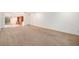 Expansive living room featuring neutral carpet and open layout at 6613 Independence St, Arvada, CO 80004