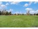 Expansive green field in a community park, perfect for recreation and outdoor activities under a bright sky at 6613 Independence St, Arvada, CO 80004