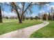 Scenic park path winds through lush green space, providing a peaceful retreat and recreational space at 6613 Independence St, Arvada, CO 80004