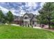 Spacious backyard with lush lawn, inviting patio area, and mature trees offering shade and privacy at 9121 Sunshine Meadow Pl, Parker, CO 80134