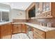 Basement bar with wooden cabinetry, granite counters, mosaic tile backsplash, and a stainless-steel beverage fridge at 9121 Sunshine Meadow Pl, Parker, CO 80134