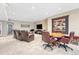 A finished basement featuring a seating area, media center, and game table under recessed lighting at 9121 Sunshine Meadow Pl, Parker, CO 80134