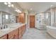 This is a luxury bathroom with granite countertops, double sinks, and a glass shower at 9121 Sunshine Meadow Pl, Parker, CO 80134