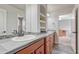 This bathroom has granite countertops, double sinks, and neutral decor at 9121 Sunshine Meadow Pl, Parker, CO 80134
