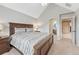 This secondary bedroom has neutral colors, carpet floors, and an en-suite bathroom at 9121 Sunshine Meadow Pl, Parker, CO 80134