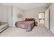 Bedroom with a comfortable bed, cozy sitting area, and access to additional living space at 9121 Sunshine Meadow Pl, Parker, CO 80134