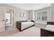 This secondary bedroom is painted in neutral colors with an attached bathroom at 9121 Sunshine Meadow Pl, Parker, CO 80134