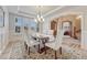 Formal dining room with elegant lighting, wainscoting, and a spacious dining table at 9121 Sunshine Meadow Pl, Parker, CO 80134