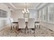 Formal dining room with elegant lighting, wainscoting, and a spacious dining table at 9121 Sunshine Meadow Pl, Parker, CO 80134
