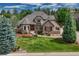 Charming two-story home featuring stone accents, a landscaped yard, and a welcoming entrance at 9121 Sunshine Meadow Pl, Parker, CO 80134