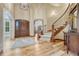 Elegant foyer with a grand staircase, hardwood floors, and a soaring ceiling at 9121 Sunshine Meadow Pl, Parker, CO 80134