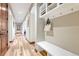 This is a hallway with wooden floors, a bench, and decorative shelving at 9121 Sunshine Meadow Pl, Parker, CO 80134