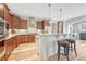 Well-lit kitchen with wooden cabinets, modern appliances, and barstool seating at the island at 9121 Sunshine Meadow Pl, Parker, CO 80134