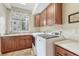 This is a laundry room with built in cabinets, countertops and front load washer and dryer at 9121 Sunshine Meadow Pl, Parker, CO 80134