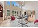 Cozy living room with tall windows, fireplace, and comfortable seating arrangement at 9121 Sunshine Meadow Pl, Parker, CO 80134