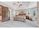 This is a primary bedroom with a ceiling fan, neutral decor, and gray carpet at 9121 Sunshine Meadow Pl, Parker, CO 80134