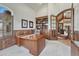 Bright home office featuring a large desk, built-in bookshelves, and classic architectural details at 9121 Sunshine Meadow Pl, Parker, CO 80134