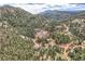 An aerial view showing homes nestled in a beautiful and expansive forested mountain landscape at 795 Pine Brook Rd, Boulder, CO 80304