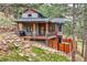 Stunning backyard with a deck, hot tub, and steps leading to a serene outdoor space at 795 Pine Brook Rd, Boulder, CO 80304