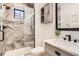 Stylish bathroom features a walk-in shower with decorative tile and vanity with marble countertop at 795 Pine Brook Rd, Boulder, CO 80304
