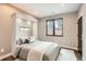 Cozy bedroom features a Murphy bed, modern decor, neutral walls, and a dark frame window at 795 Pine Brook Rd, Boulder, CO 80304