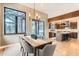 Elegant dining room with a view to the modern kitchen and sliding doors opening to the outdoors at 795 Pine Brook Rd, Boulder, CO 80304