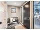 Inviting entryway with sleek black door, bench seating, and a view to the outdoors through a side window at 795 Pine Brook Rd, Boulder, CO 80304
