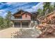 Stunning modern two-story home with a two-car garage and beautiful stone accents nestled on a hillside at 795 Pine Brook Rd, Boulder, CO 80304