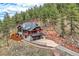 Aerial view of a two-story home with a two-car garage, and scenic mountain views at 795 Pine Brook Rd, Boulder, CO 80304