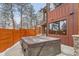 Backyard patio with a hot tub and privacy fence, surrounded by snow covered trees at 795 Pine Brook Rd, Boulder, CO 80304