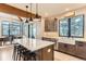 Bright kitchen featuring a large island with seating, modern appliances, and a dining area at 795 Pine Brook Rd, Boulder, CO 80304