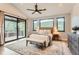 Serene main bedroom with a vaulted ceiling, large windows, and access to a private deck with mountain views at 795 Pine Brook Rd, Boulder, CO 80304