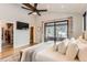 Cozy main bedroom with a vaulted ceiling, TV, and access to a private deck with snow-covered mountain views at 795 Pine Brook Rd, Boulder, CO 80304